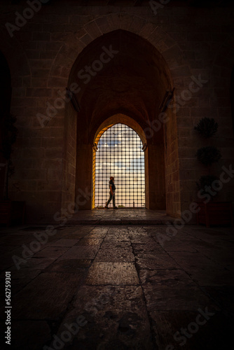 Inside viev of Kasimiye Madrasah of Mardin Province, beautiful stone architecture religion school with colorful sunset light and fences and people