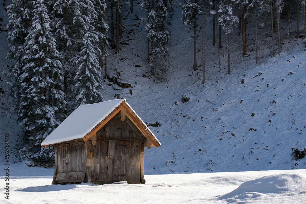 a wood hut on a agriculture field in winter