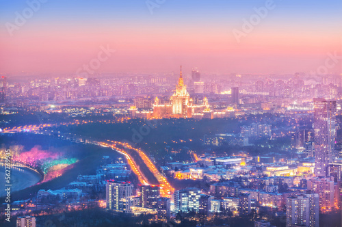 View of the city from the observation deck to skyscrapers in the light of night lights, Moscow River and Moscow State University, Moscow City