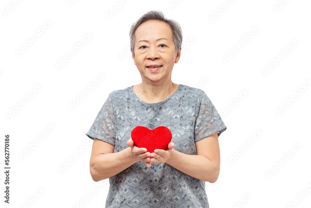 Senior asian woman holding red heart, giving love with smile isolated on white background Senior asian woman holding red heart, giving love with smile isolated on white background