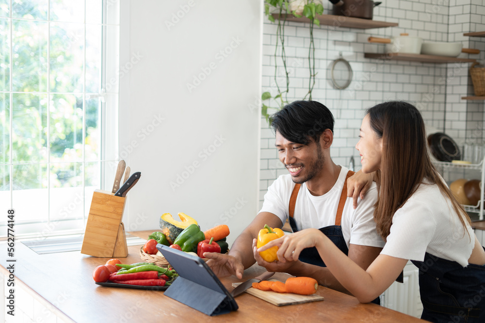 Couple cooking together. Happy young couple cooking together in the kitchen. valentine day concept. Couple cooking together. Happy young couple cooking together in the kitchen. valentine day concept.