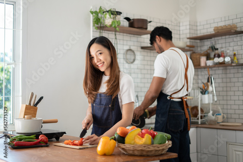 Couple cooking together. Happy young couple cooking together in the kitchen. valentine day concept.