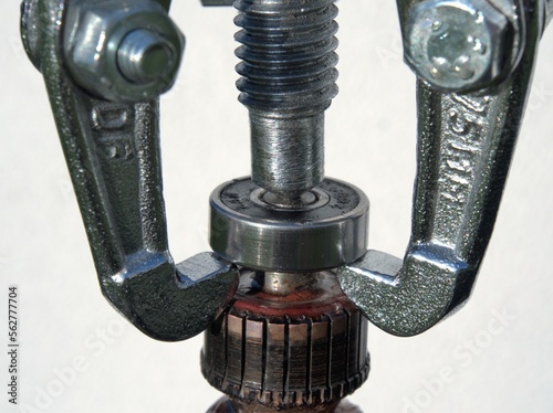 Removing the ball bearing with a bearing puller. Repair of electric tools photo