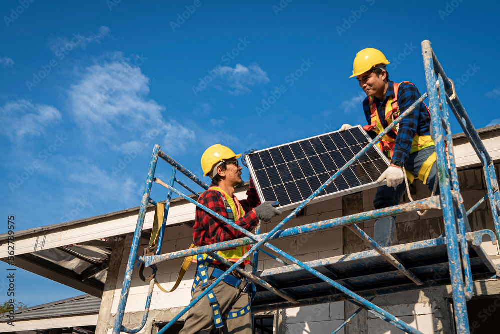 Technician installing solar panels on sunny day Technician installing solar panels on sunny day