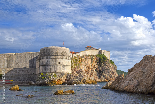 Dubrovnik West Harbor and view to the ancient city wall on the rocks, Dubrovnik, Croatia photo