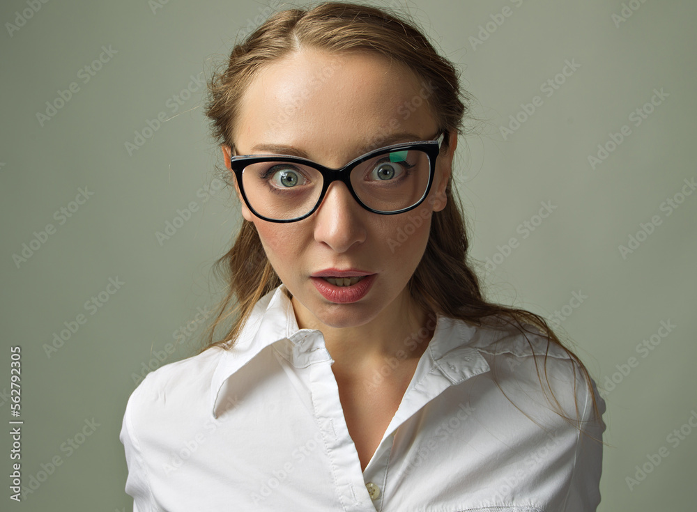 Closeup portrait of surprised business woman looking shocked open eyes with glasses, isolated on green background. Human emotion facial.