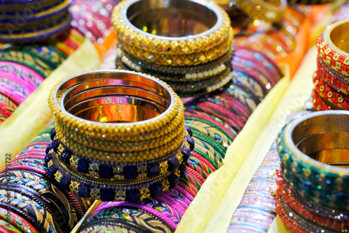 Indian Gold bangles displayed in local shop in a market of Pune, India, These bangles are made of Gold and diamond as beauty accessories by Indian women, selective focus.