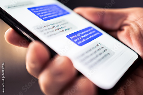 Text message in phone. Send sms with smartphone. Mobile conversation and texting in instant messaging and online chat app in cellphone. Communication in business network. Discussion in dark at night.