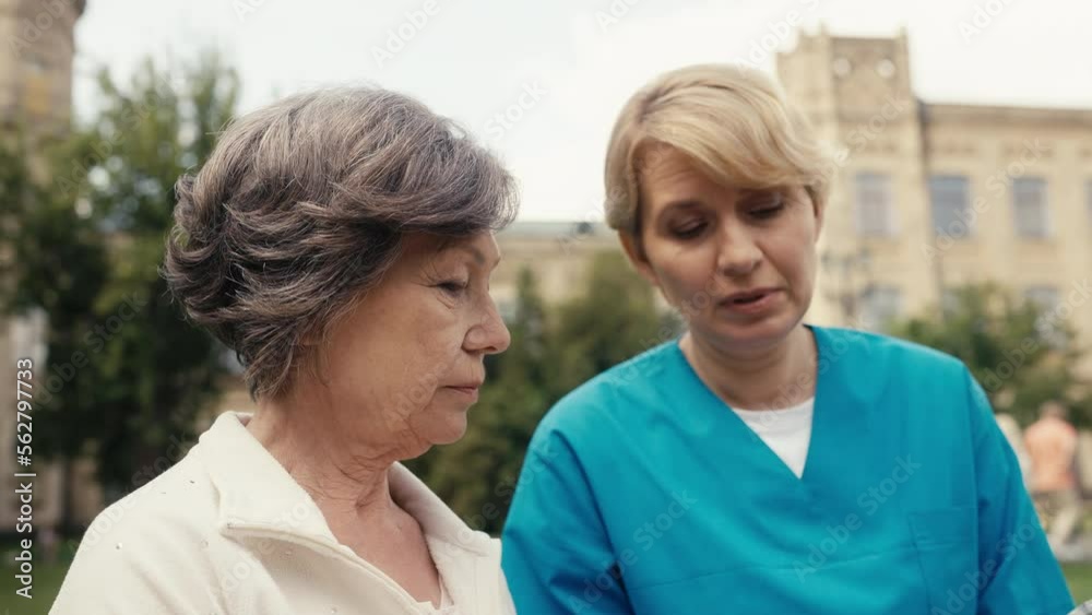 Close-up of medical clinic doctor talking with her senior female patient, help Close-up of medical clinic doctor talking with her senior female patient, help