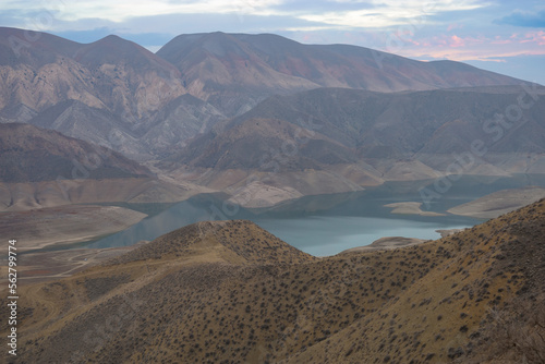 Azat reservoir with Yeranos mountain range in the background. Beautiful dramatic colorful cloudy sunset in a rocky canyon.