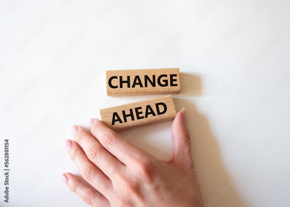 Change ahead symbol. Wooden blocks with words Change ahead. Businessman hand. Beautiful white background. Business andChange ahead concept. Copy space. Change ahead symbol. Wooden blocks with words Change ahead. Businessman hand. Beautiful white background. Business andChange ahead concept. Copy space.
