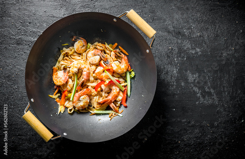 Chinese wok. Asian Udon noodles with shrimp and vegetables.