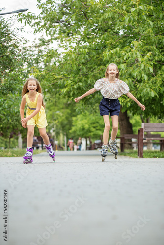 Two children are rollerblading at skate park. Concept of an active lifestyle, hobbies and childhood