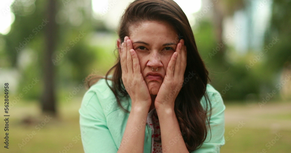 Angry young woman screaming from the top of her lungs feeling distraught Angry young woman screaming from the top of her lungs feeling distraught