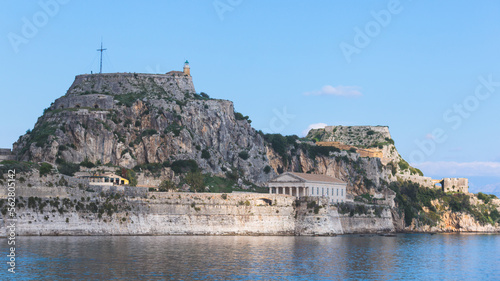 View of Old Venetian Fortress of Corfu, Palaio Frourio, Kerkyra old town, Greece, Ionian sea islands, with the lighthouse, Clock tower, st. George church and the city, a blue sky summer sunny day photo