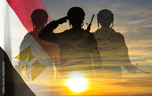 Silhouettes of soldiers against the sunset with Egypt flag. Background for National Holidays. Concept - Armed Forces. EPS10 vector
