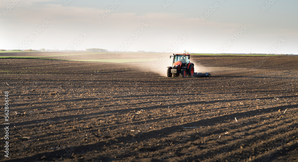 Farmer preparing his field in a tractor Farmer preparing his field in a tractor