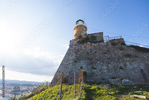 View of Old Venetian Fortress of Corfu, Palaio Frourio, Kerkyra old town, Greece, Ionian sea islands, with the lighthouse, Clock tower, st. George church and the city, a blue sky summer sunny day photo