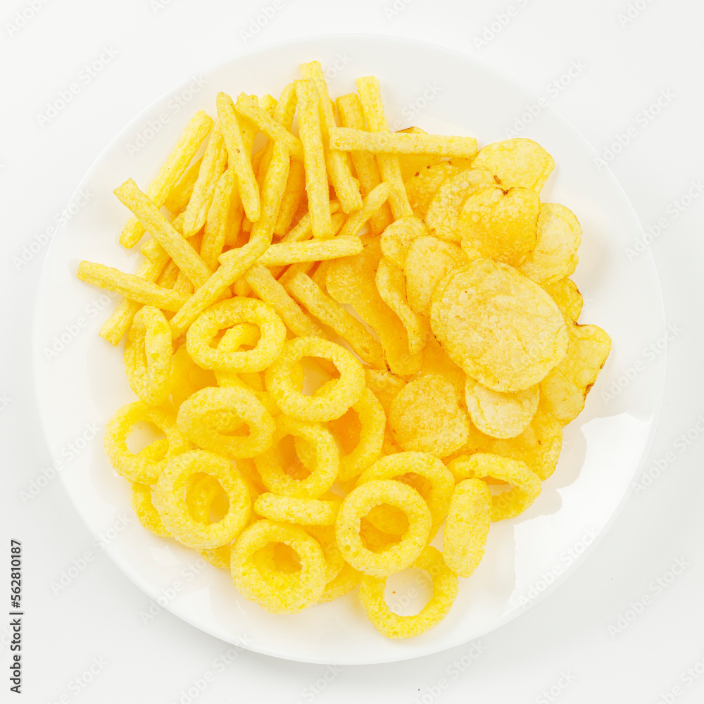 A plate of corn chips snacks with cheese on a white background. A plate of corn chips snacks with cheese on a white background.