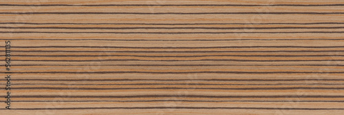Zebra tree. Texture of brown wood with horizontal black stripes. African zebrano wood texture on macro. Photo in very high resolution. photo