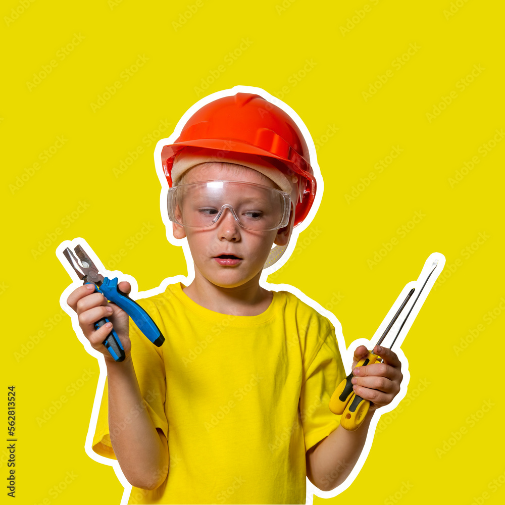 a boy in an orange construction helmet with safety glasses, in a yellow T-shirt, with pliers and screwdrivers in his hands is framed by a white stripe along the contour. a boy in an orange construction helmet with safety glasses, in a yellow T-shirt, with pliers and screwdrivers in his hands is framed by a white stripe along the contour.