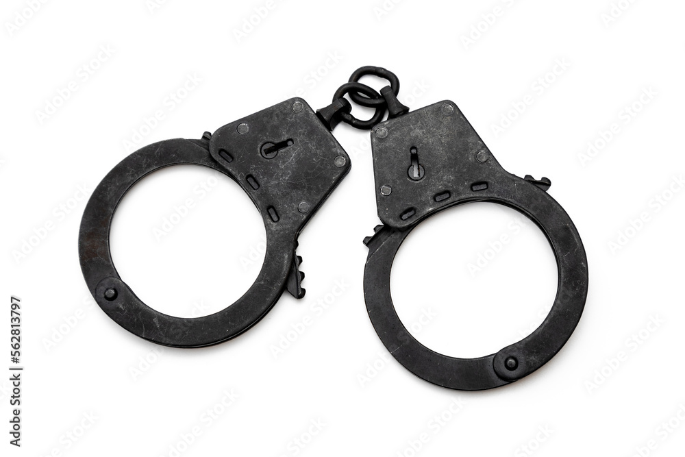 metal police handcuffs in black on a white background metal police handcuffs in black on a white background