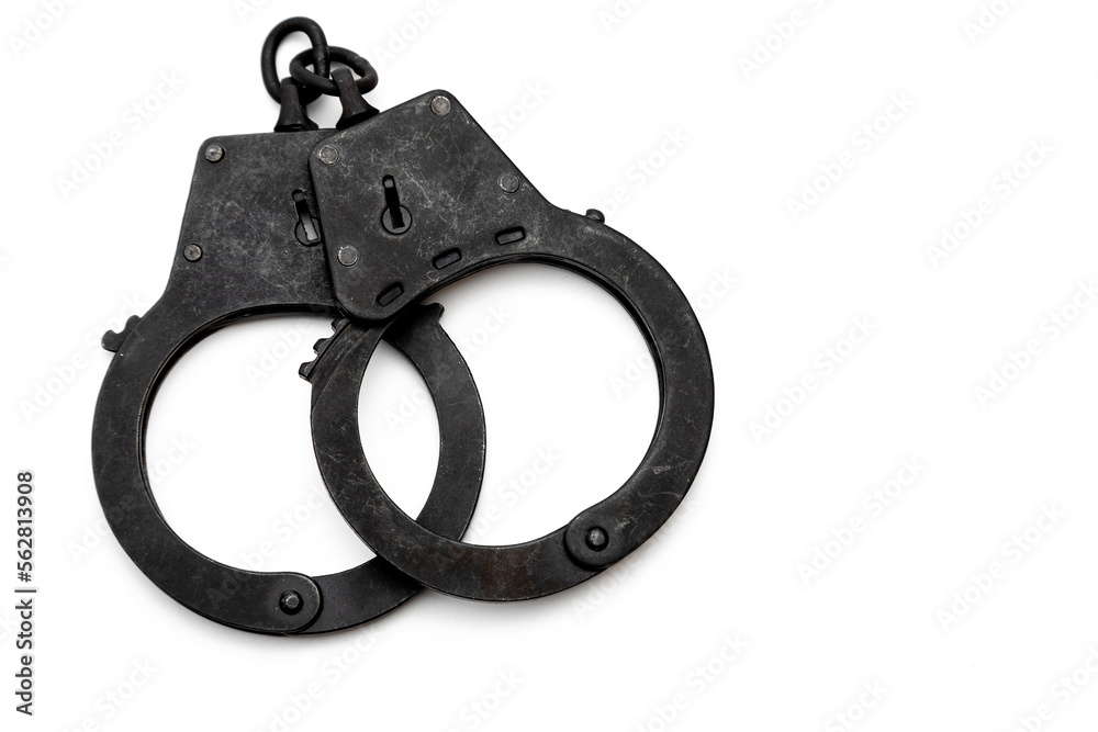 metal police handcuffs in black on a white background metal police handcuffs in black on a white background
