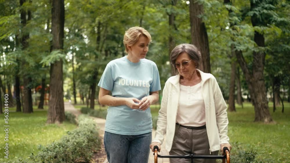 Slow motion of volunteer supporting senior woman with disability, social care Slow motion of volunteer supporting senior woman with disability, social care