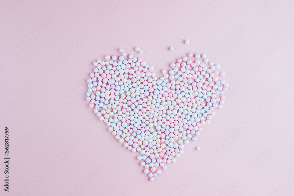 Heart shape made of pastel multicolored polyfoam balls.