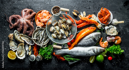 Variety of fresh seafood with herbs and lime.