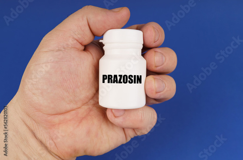 On a blue background in the hands of a man is a white jar with the inscription - Prazosin photo