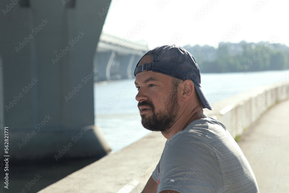 Fototapeta premium Portrait of a young athlete on the embankment