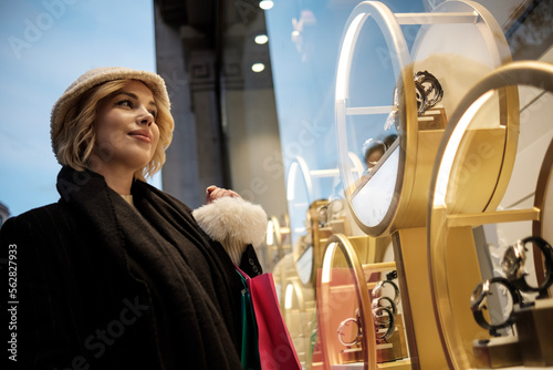 Canvastavla Portrait of young woman looking at a window shop jewelry.