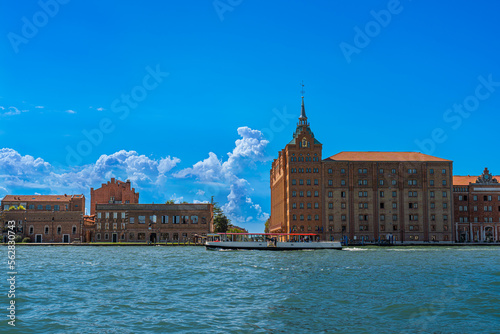 Water public transport, sea taxi on the Grand Canal in the city of Venice, blue sky over the sea and vintage houses, the movement of sea urban transport on a sunny day on the main street of Venice
