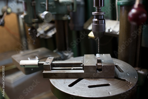 Part machining with drilling machine photo