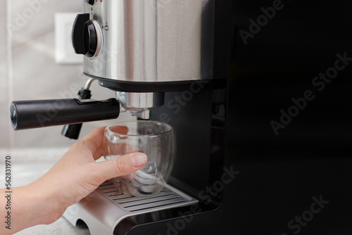 prepares coffee in a coffee machine at home. for text