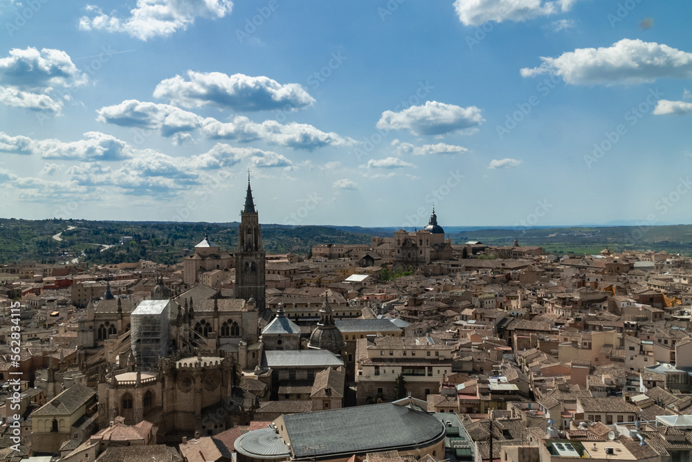 Toledo, España. April 29, 2022: Toledo Cathedral with blue sky and panoramic city landscape.