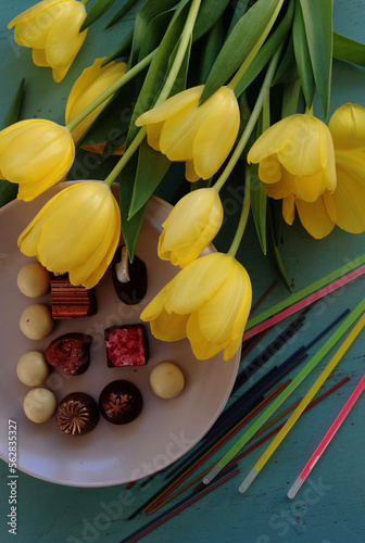 yellow tulips and handmade candies on the table, good morning sweetheart