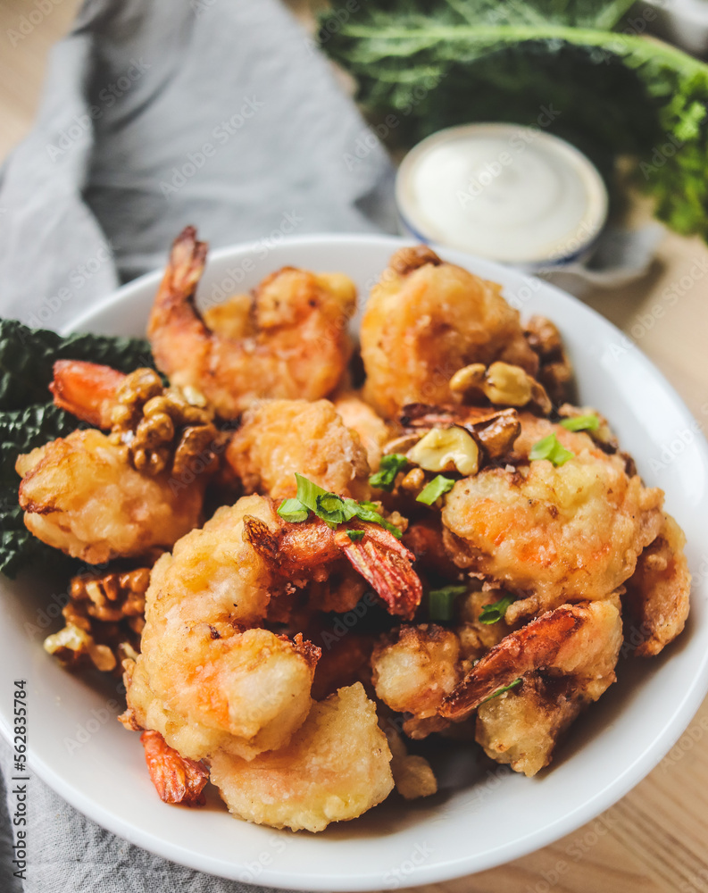 fried shrimp in batter with nuts on a plate close-up, breaded seafood fried shrimp in batter with nuts on a plate close-up, breaded seafood