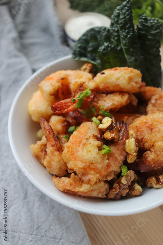 fried shrimp in batter with nuts on a plate close-up, breaded seafood