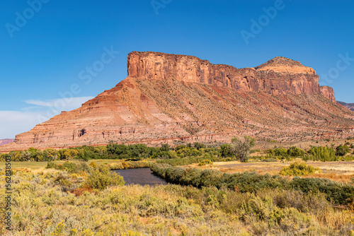 River meandering at the base of a red butte in Captial Reef National Park Utah. 
