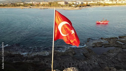 The Turkish flag is proudly flying on a mast, its red and white crescent and star symbols symbolizing the nation's identity and sovereignty in the wind photo