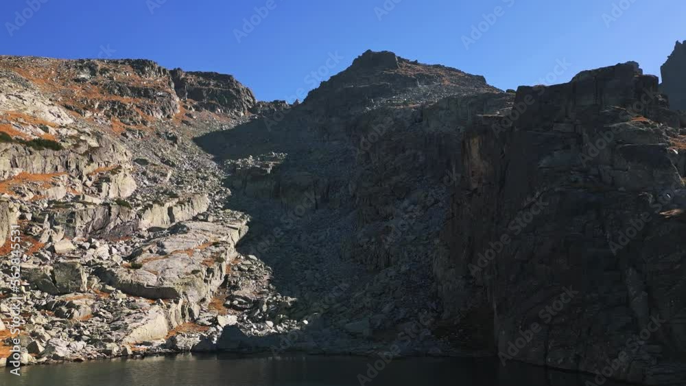 Strashnoto lake - drone video of a scenic autumn landscape in the Rila mountain, Bulgaria. Aerial nature shot. Strashnoto lake - drone video of a scenic autumn landscape in the Rila mountain, Bulgaria. Aerial nature shot.