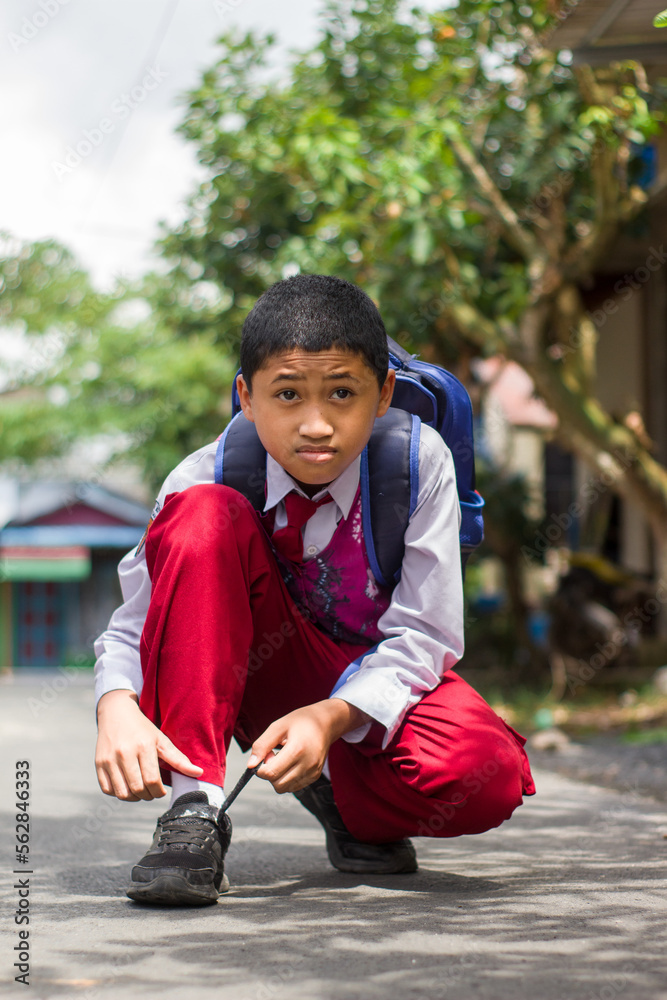 Photo inspiration: Gallery Detail: Indonesian Student In Uniform Getting Ready For School By Tying
