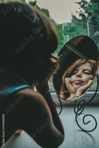 girl looking at herself in the mirror