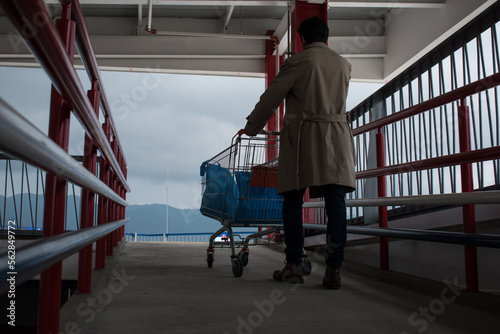Man walking up the ramp with a market car