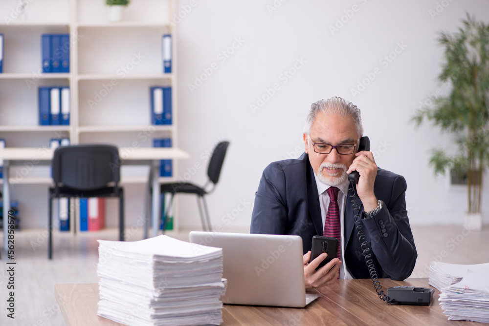 Old male employee and too much work in the office Old male employee and too much work in the office