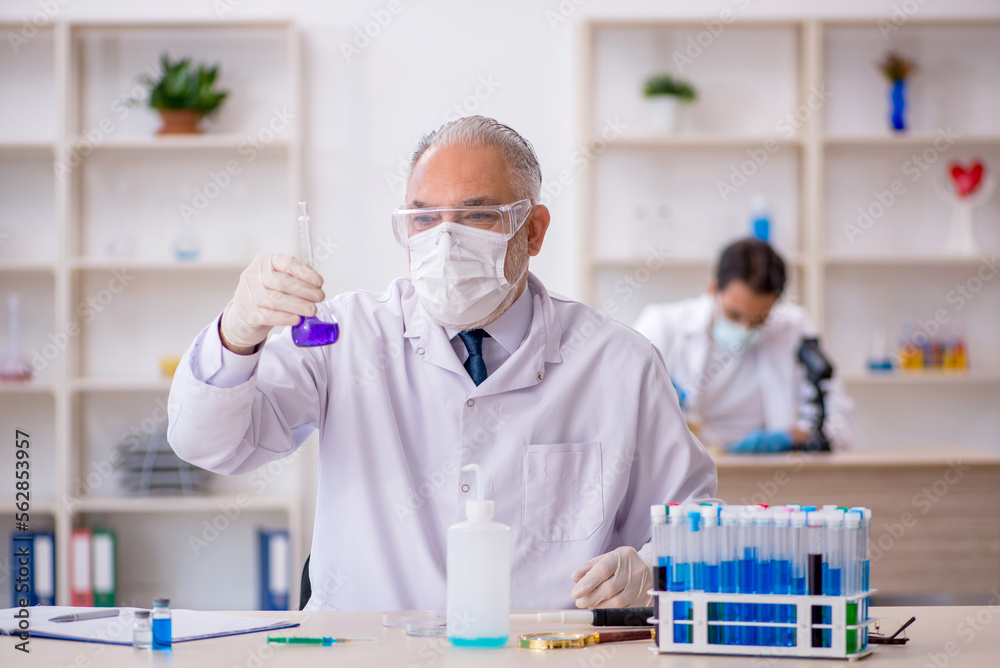 Two male chemist working at the lab Two male chemist working at the lab