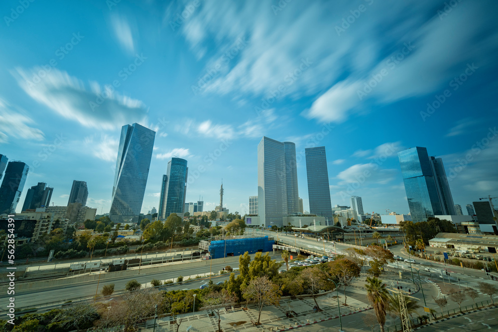Aerial view of Tel Aviv skyline with urban skyscrapers at sunset and cars on Ayalon highway, Israel