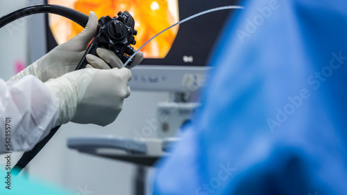 Close up photo of surgeon 's hands inside modern operating room in blue surgical gown suit. Doctor using endoscopic retrograde cholangio pancreatography in gall stone patient with abdominal pain.